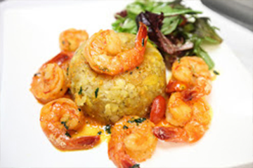 Mashed green plantains with garlic, olive oil, pork rinds, and shrimp